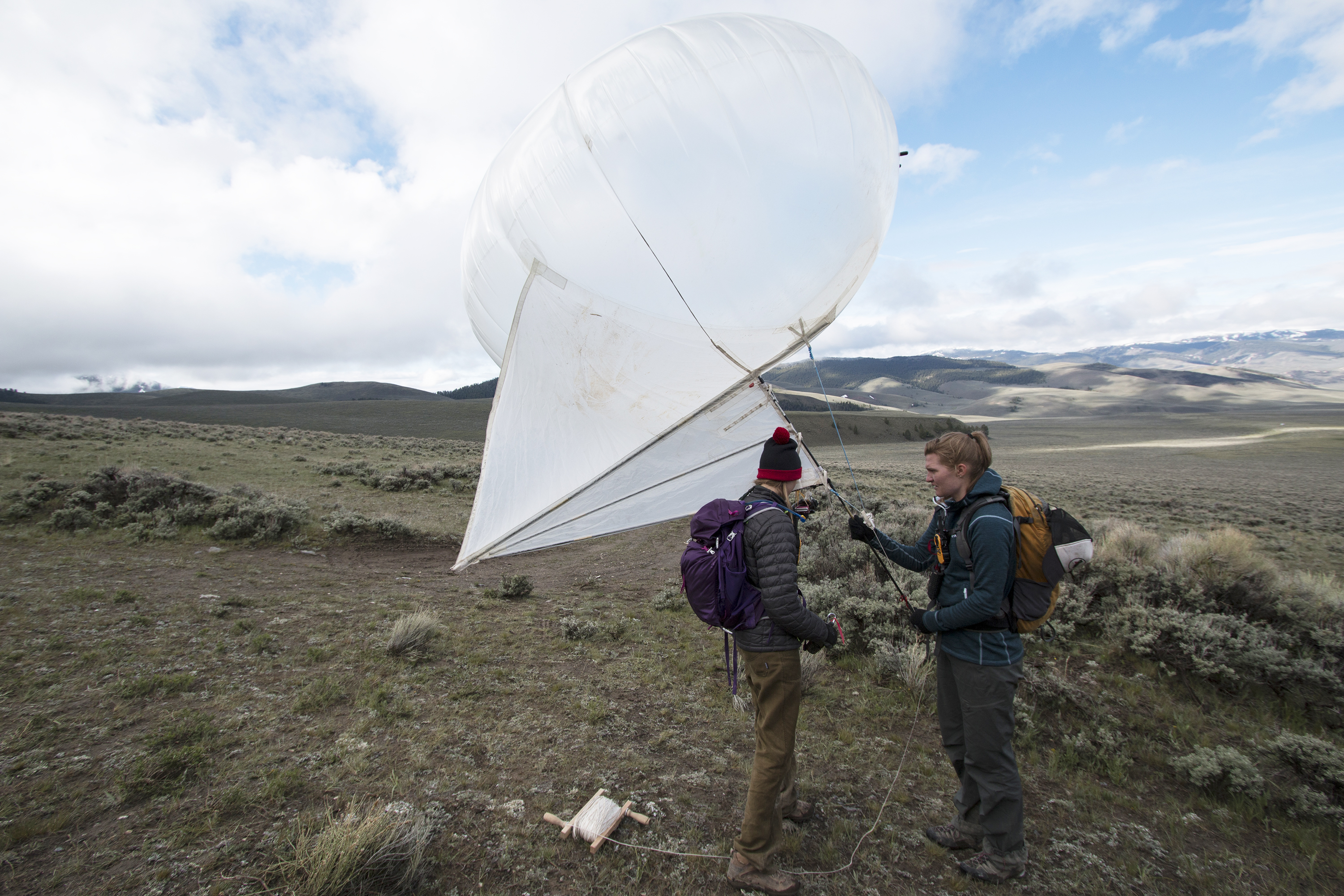 Colorado School of Mines graduate students Kendra Johnson and Lia Lajoie prepare a helikite (tethered balloon) to launch for the collection of photographs along the 1983 Borah Peak earthquake rupture.