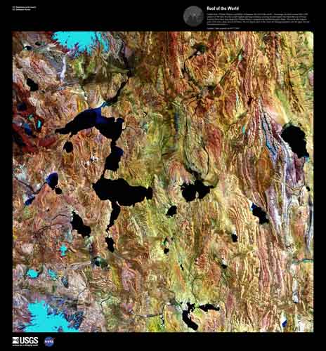 Colorful rough terrain with scattered black lakes.